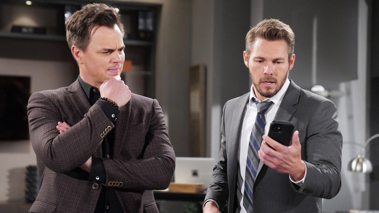 The Bold and the Beautiful's Wyatt and Liam looking at a phone