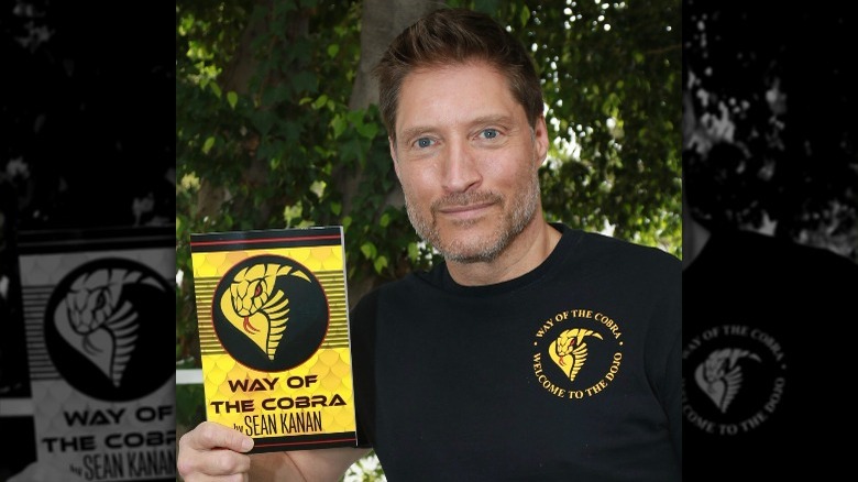 Sean Kanan holding up a copy of "Way of the Cobra"