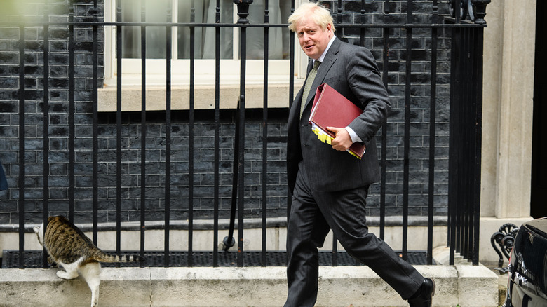 Larry the cat and Boris Johnson walking