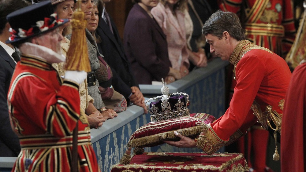 Guards placing crown down gently