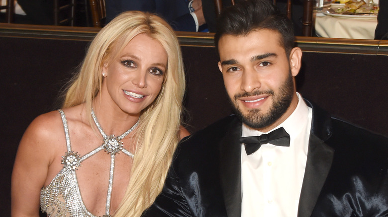 Britney Spears and her fiance Sam Asghari smiling together at an event