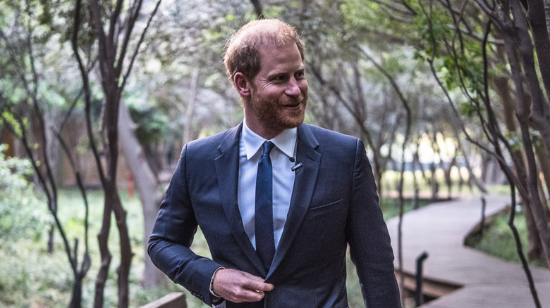 Prince Harry smiling and walking