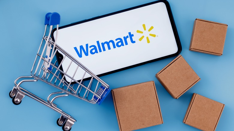 Walmart logo on phone in mini shopping cart