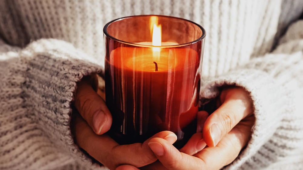 Woman holding a burning candle