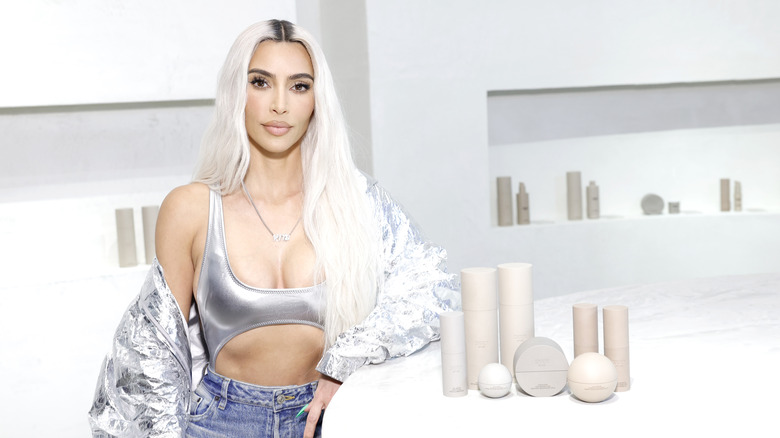 Kim Kardashian next to SKKN products