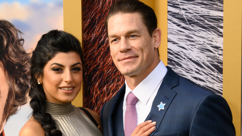 Shay Shariatzadeh and John Cena posing 