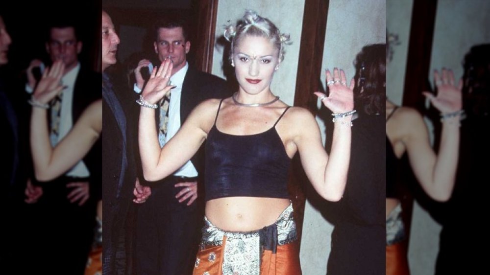 Gwen Stefani wearing a crop top and red lipstick