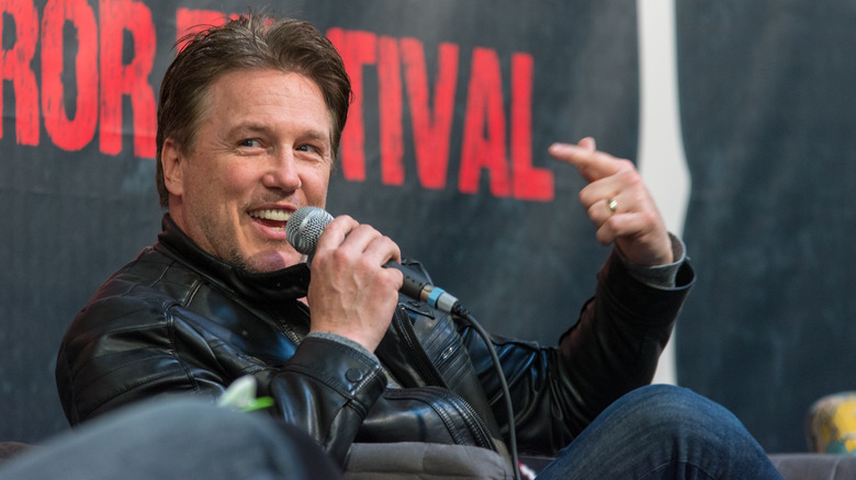 Lochlyn Munro points at himself onstage