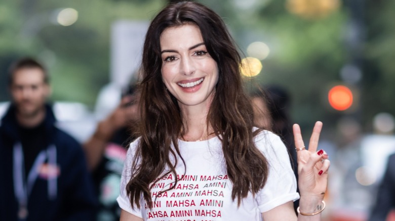 Anne Hathaway smiling peace sign