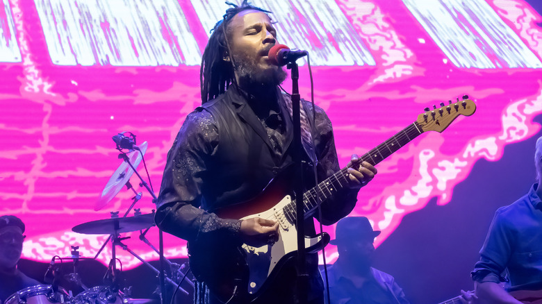 Ziggy Marley singing and playing guitar