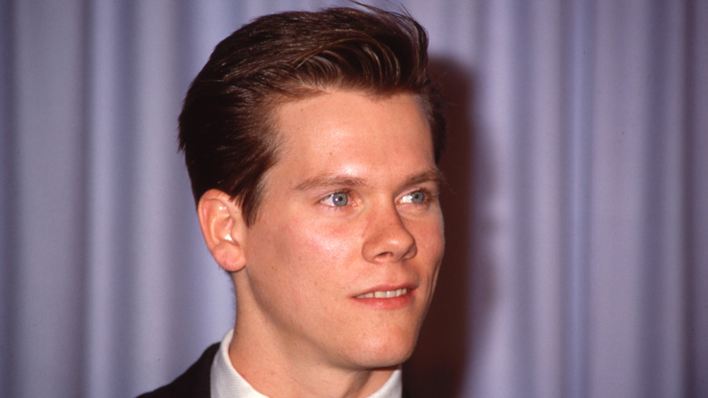 young Kevin Bacon looking side