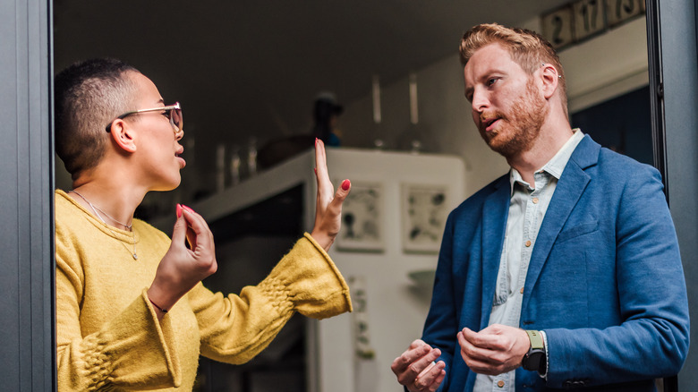 couple arguing in doorway