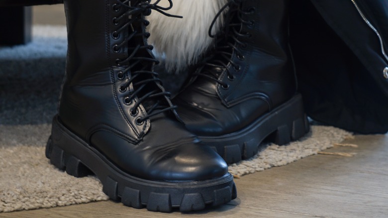 Black combat boots on floor