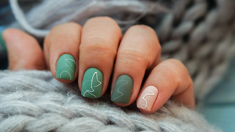 Tonal forest green nails with designs