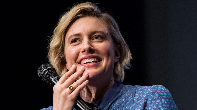 Greta Gerwig smiling with mic