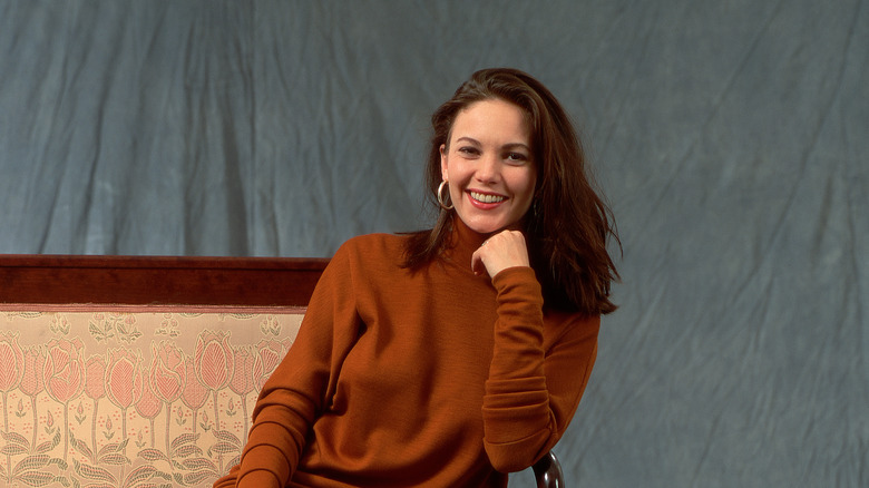 Diane Lane sitting on sofa