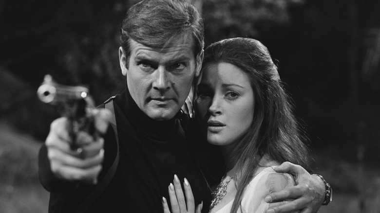 Jane Seymour and Roger Moore posing 