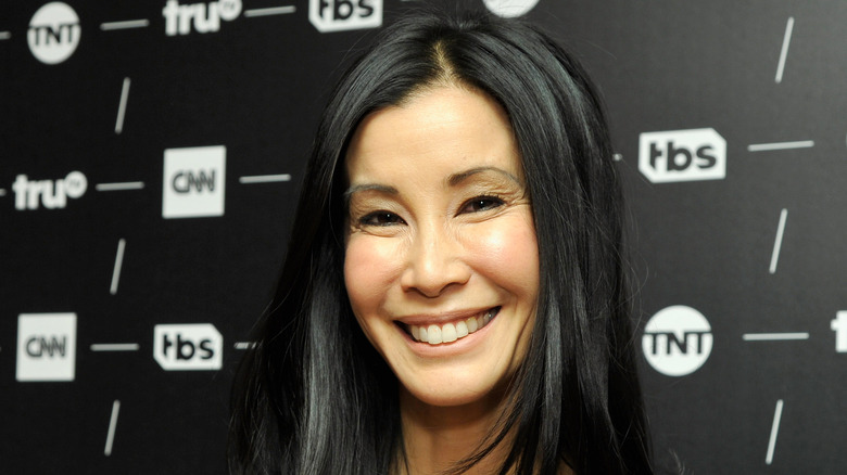 Lisa Ling smiling while looking to the side