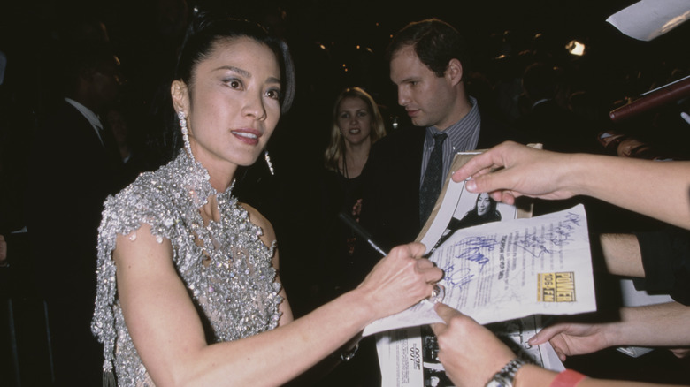 Michelle Yeoh signing autographs in silver dress