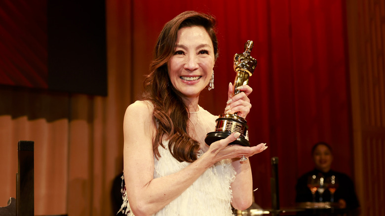 Michelle Yeoh smiling with her Oscar 