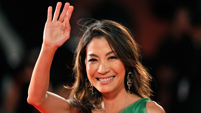 Michelle Yeoh waving in green dress