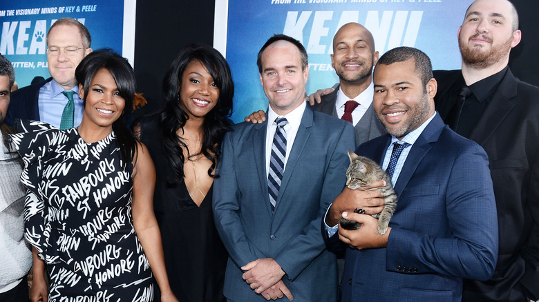 Nia Lomg posing with the cast of Keanu 