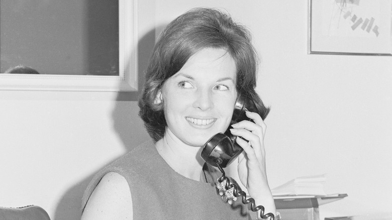 Young Pamela Turnure Timmins talking on the phone