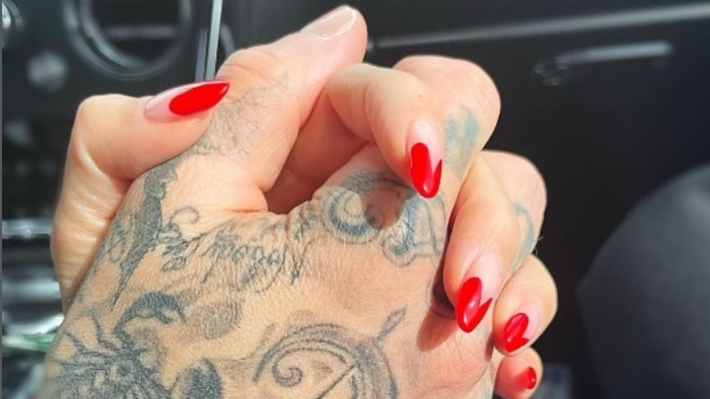 Kourtney Kardashian and Travis Barker's hands, clasped together