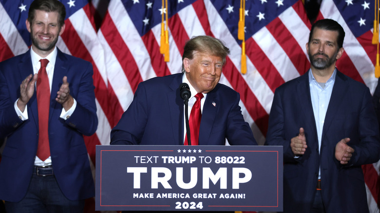 Donald Trump on stage with Eric and Donald Jr.