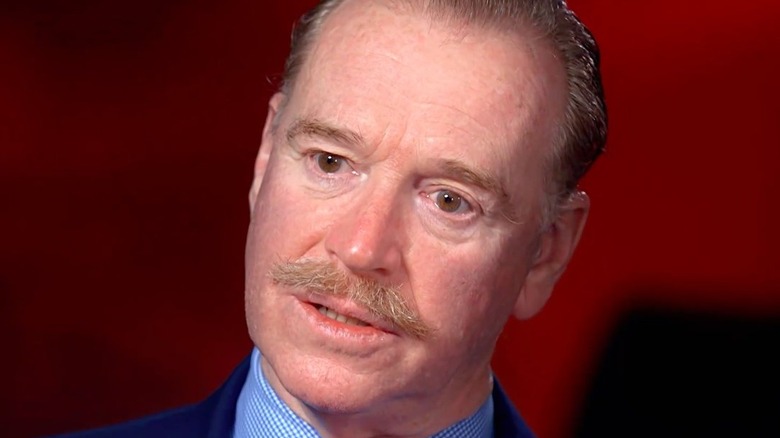 James Hewitt sporting a mustache and looking intense