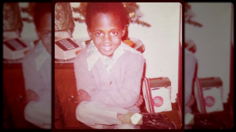 A young Wayne Brady smiling