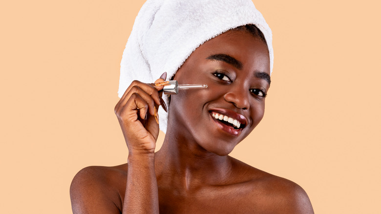 A woman applying retinol 