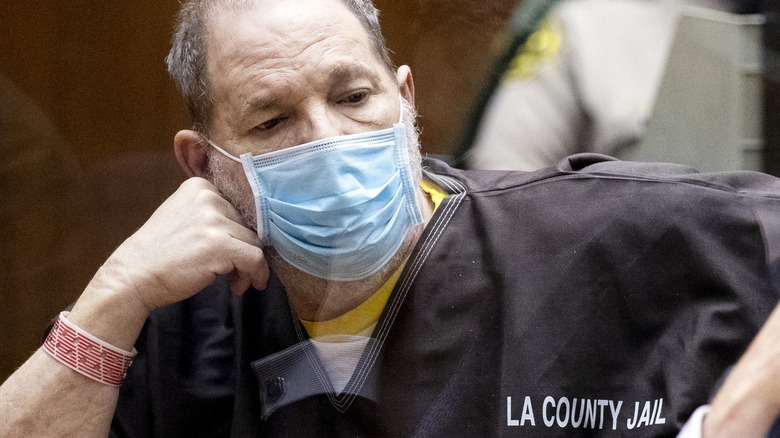 Harvey Weinstein wearing a mask and his county jail uniform