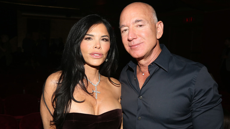 Jeff Bezos and Lauren Sánchez posing at an event in all black