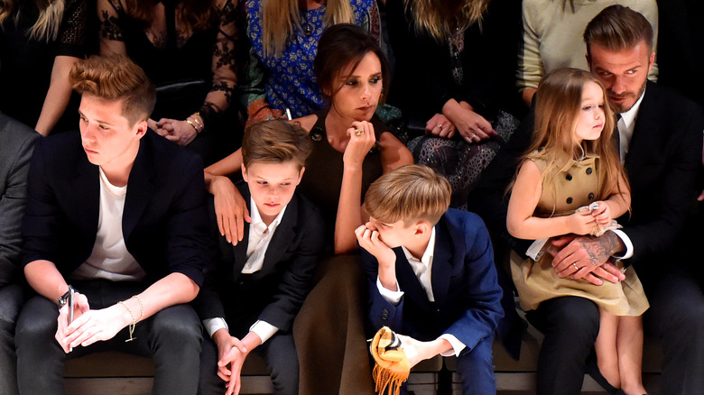 Victoria Beckham seated with her family