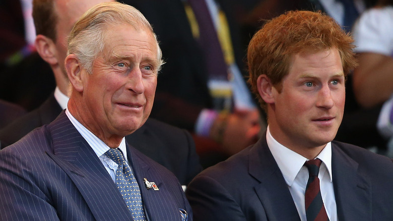 Prince Charles and Prince Harry sitting awkwardly at an event