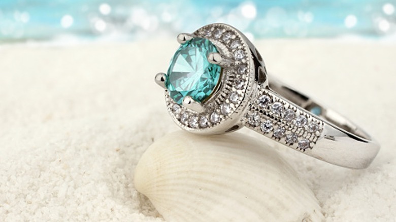 An aquamarine ring on beach