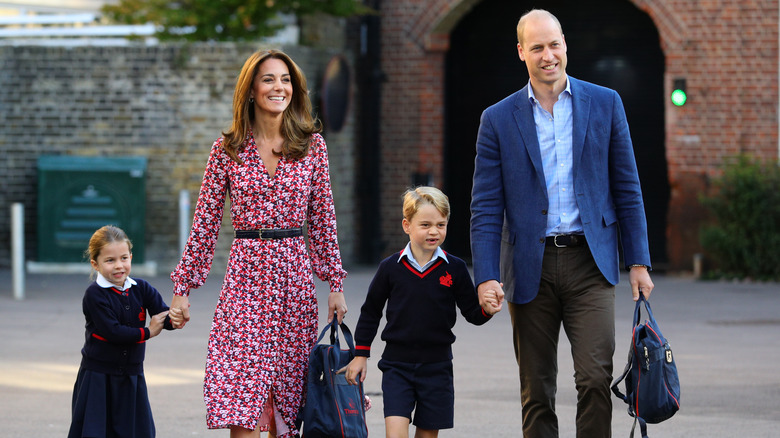 Princess Charlotte and Prince George hold hands with their parents