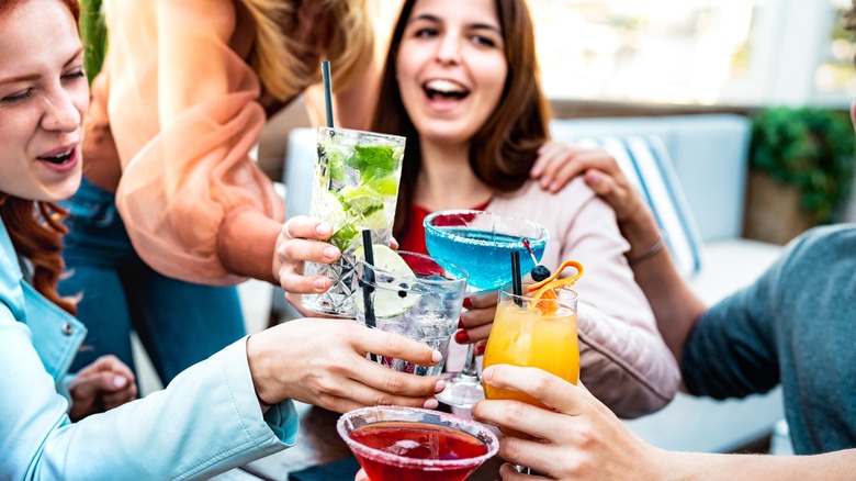 Friends cheersing drinks.