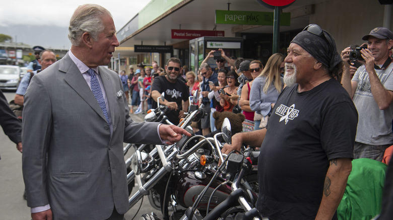 King Charles talking to motorcyclist