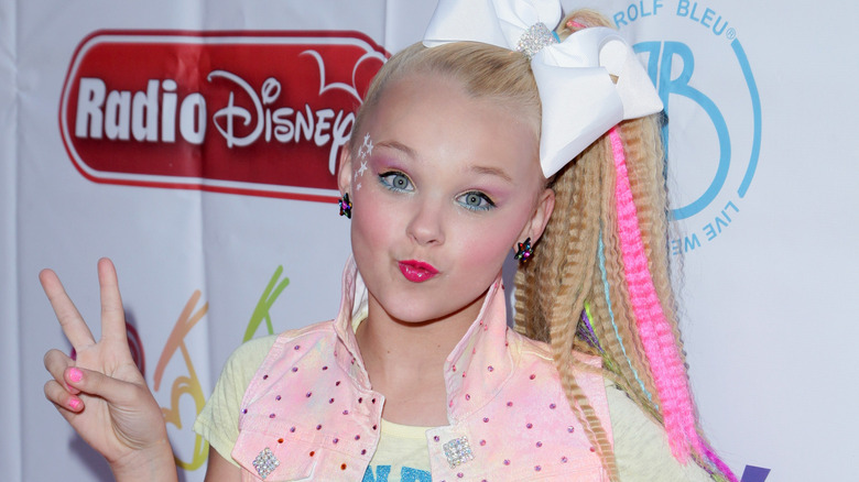 JoJo Siwa posing in a dotted vest