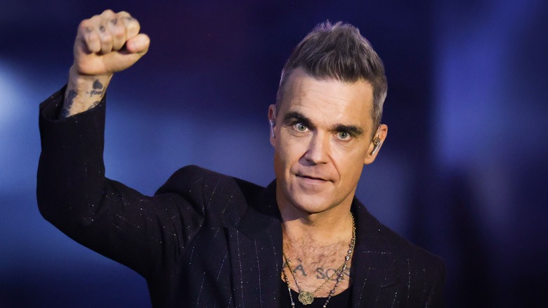 Robbie Williams raising his fist