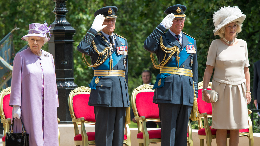 Prince Charles saluting with Philip