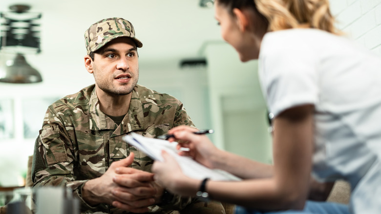 doctor talking to young service member