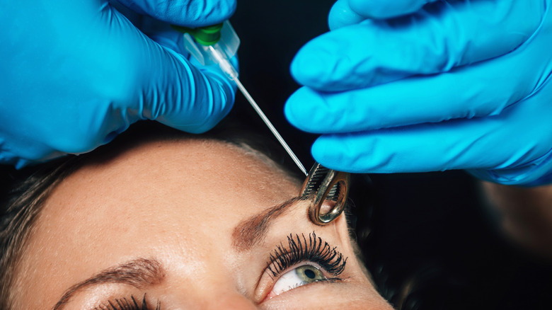 woman getting her eyebrow pierced