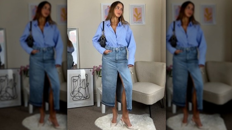 A woman wearing a denim maxi skirt and button up shirt