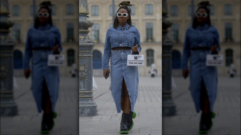 Woman wearing denim jacket and skirt