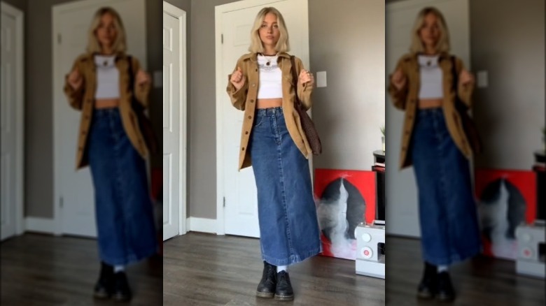 A woman wearing a shacket and denim maxi skirt