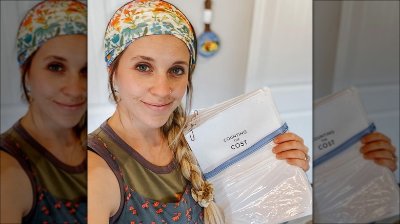 Jill Duggar holding book manuscript