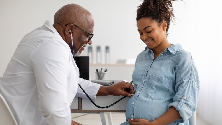 Pregnant woman with her doctor